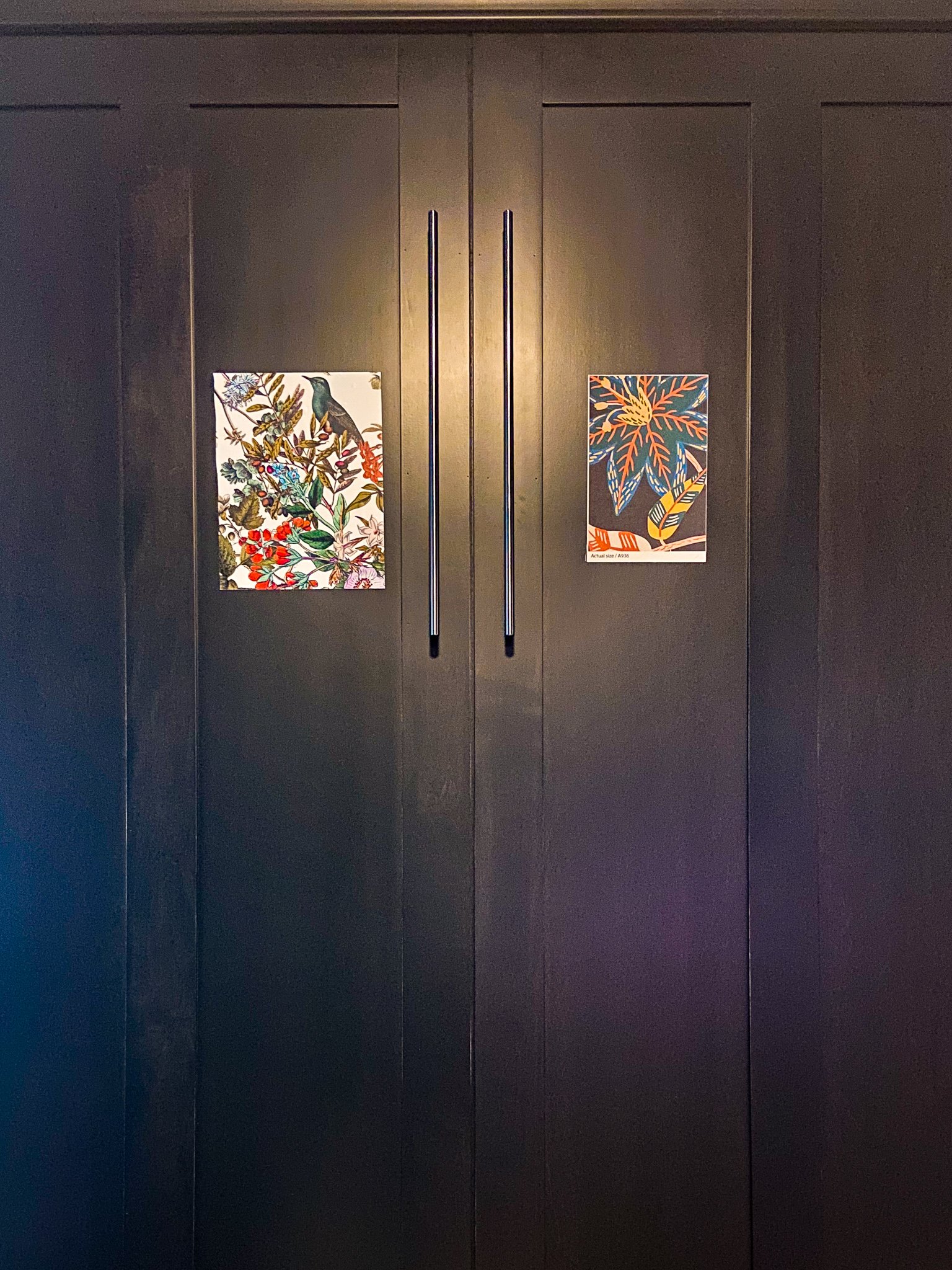 These are two wallpaper samples on a dark brown Murphy bed.