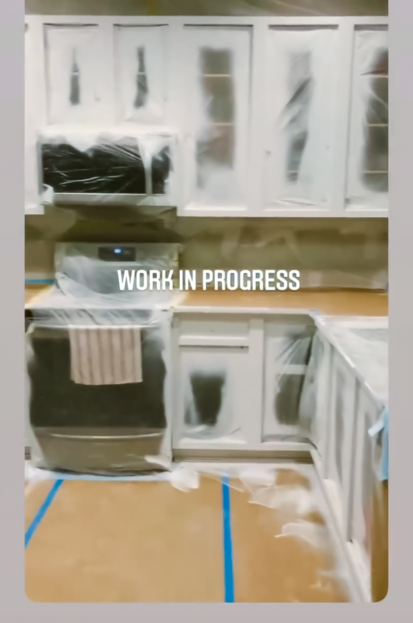 This is a kitchen where the cabinets have been covered in plastic so the cabinets can be painted with a spray gun.